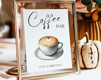 Könnte beinhalten: Ein goldfarbener Rahmen mit dem Text "Coffee Bar" und dem Satz "Love is Brewing" unter einer Aquarell-Illustration einer Tasse Kaffee mit einem Herz-Design im Schaum.