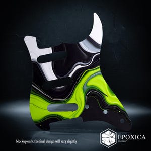May include: A guitar pickguard featuring a marbled pattern of black, white, and neon green swirls. The pickguard has three pickup cutouts and several screw holes. Text at the bottom reads: Mockup only, the final design will vary slightly. EPOXICA Guitars.