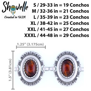 May include: Two silver conchos with oval, amber-colored centers. Each concho is 1.5 inches (3.81cm) tall and 1.25 inches (3.175cm) wide. The image includes text indicating sizes from S to XXXL and the number of conchos per size. The brand name is Shovelle, created in the USA.