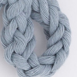 May include: A close-up of a light blue braided rope. The rope is made of a soft, natural fiber and has a slightly textured surface.