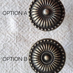 May include: A set of three ceramic mugs with a speckled, matte finish in cream, light grey, and dark grey. Each mug has a simple, minimalist design and a rounded handle.