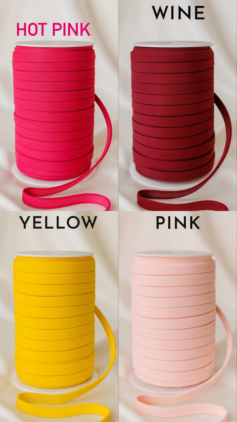 May include: Four spools of elastic ribbon in various colors: hot pink, wine, yellow, and pink. Each spool is labeled with its color name in capital letters. The ribbon is neatly rolled and displayed against a white background.