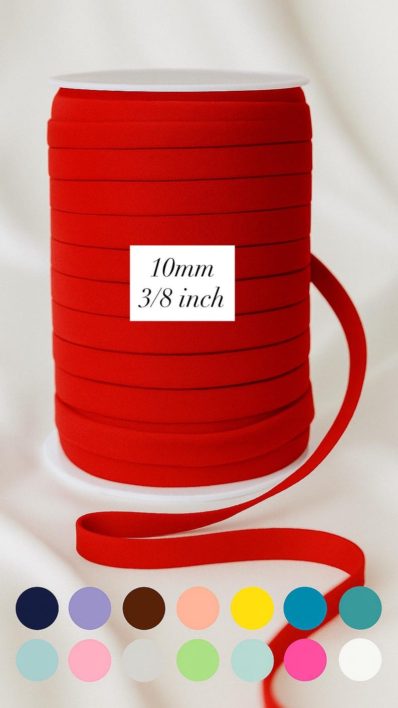 May include: A spool of bright red bias tape, 10mm (3/8 inch) wide, is displayed against a white background. The text "10mm 3/8 inch" is printed on a white square. A selection of color swatches is shown below.