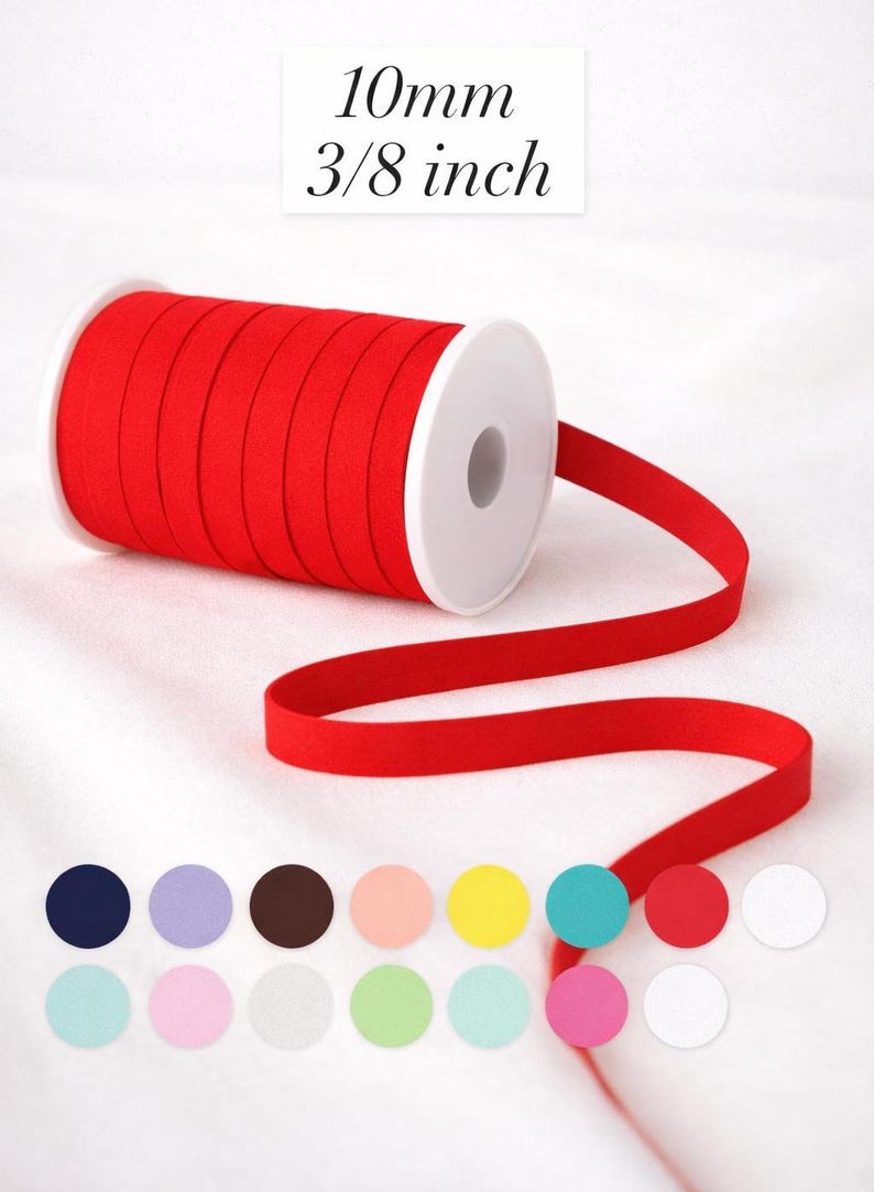 May include: A spool of red elastic ribbon, 3/8 inch (10mm) wide, unwound to show the material. The image includes a color palette of various round colors, including navy, lavender, brown, peach, yellow, teal, pink, and white.