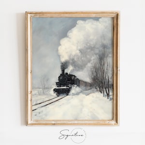 May include: A framed vintage print depicts a black steam train moving through a snowy landscape. The train emits a large cloud of white smoke against a gray sky. Bare trees line the tracks, and the print is in a gold-colored frame.