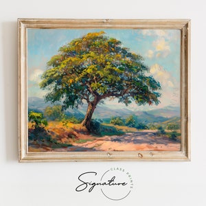 May include: A painting of a landscape with a large tree in the foreground. The tree has a thick trunk and branches that spread out over the scene. The sky is blue with white clouds. The hills in the background are green and brown. The painting is framed in a light wood frame.