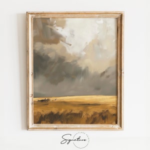 Może przedstawiać: Abstrakcyjne malarstwo przedstawiające krajobraz ze złotym polem i burzowym niebem. Obraz jest oprawiony w jasną drewnianą ramę.