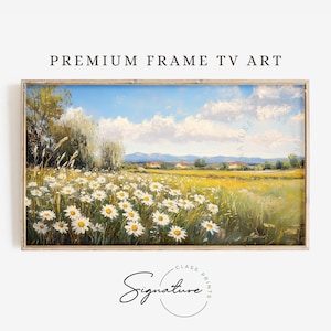 May include: A framed painting of a field of white daisies with a blue sky and white clouds in the background. The field is surrounded by green trees and a small village in the distance.