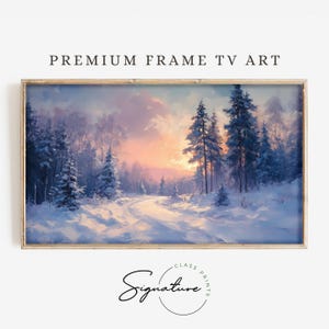 May include: A framed painting of a snowy forest scene with a path leading through the trees. The sky is a soft pink and purple, and the trees are covered in snow. The painting is in a light wood frame.