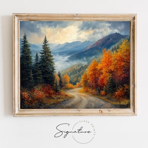 May include: A framed painting of a winding road through a forest in autumn. The trees are a mix of green and orange, and the road leads up to a mountain range in the distance. The sky is cloudy and there is a hint of fog in the valley.