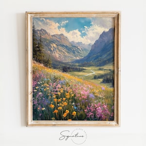 May include: A framed painting depicting a mountain valley with a river snaking through it. The valley is awash with a field of wildflowers in shades of pink, purple, yellow, and white.