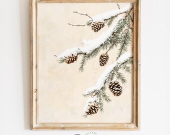 May include: A framed print of a snowy pine branch with pine cones. The background is a light beige color.