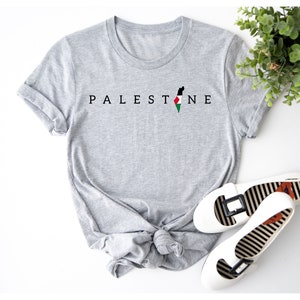 a t - shirt with the word palestine on it next to a pair of shoes