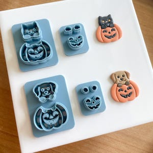 May include: Set of four blue plastic cookie cutters shaped like pumpkins and animals. The cutters are for making Halloween-themed cookies.