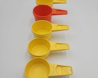 Juego de 5 vasos medidores Tupperware vintage, color naranja y amarillo, apilables.