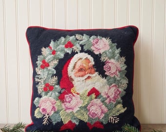 Vintage handmade wool needlepoint Christmas throw pillow santa Claus face surrounded by a floral and holly wreath