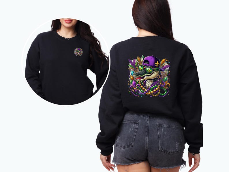 May include: Black sweatshirt with a colorful graphic of an alligator wearing sunglasses and a purple hat with beads and fleur-de-lis. The alligator is surrounded by green, purple, and gold beads.