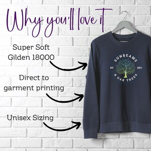 May include: Navy blue long-sleeved sweatshirt with a colorful tree graphic and the text "SUNBEAMS & OAK TREES EST 2024". The sweatshirt is made of a soft, Gildan 18000 fabric and is printed using direct-to-garment printing. It is available in unisex sizing.