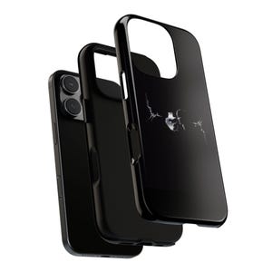 May include: Black iPhone case with a skull design. The case is glossy and features a cracked glass effect around the skull. The phone case is shown with the phone inside and two additional cases.