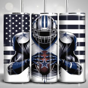 May include: A white tumbler with a design of a football player wearing a blue and white jersey and helmet, holding a football. The background is an American flag with red, white, and blue stripes.