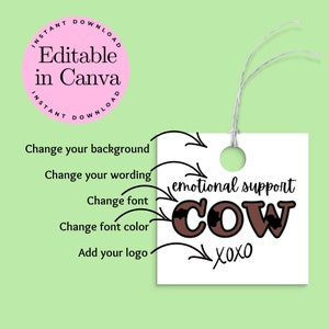 May include: A white tag with brown text that says "emotional support cow" with black cow spots. The text "XOXO" is below the cow text. The tag has a hole punched in the top and a string attached.