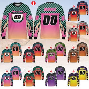 May include: Long-sleeved motocross jerseys in various colors, featuring checkered patterns, flame designs, and the number "00". Each jersey has a different color scheme, including pink, orange, green, and purple. The jerseys are displayed on a light brown background.