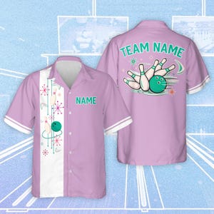 May include: A lilac bowling shirt with a white and teal bowling design. The shirt has a button-down front, short sleeves, and a white collar and cuffs. The back of the shirt features the text "TEAM NAME" above a bowling pin and ball graphic.