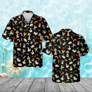 May include: Black button-down shirt with a vibrant, colorful Pride-themed pattern. The design includes rainbows, unicorns, cats, and the text "PRIDE" and "ALL MEANS ALL". The shirt has short sleeves and a classic collar.