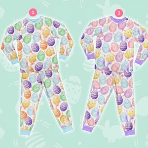 May include: Two pairs of pyjamas with a white background and a colourful Easter egg pattern. The pyjamas have long sleeves and long trousers. The pyjamas are in different colours, one with blue trim and one with purple trim.