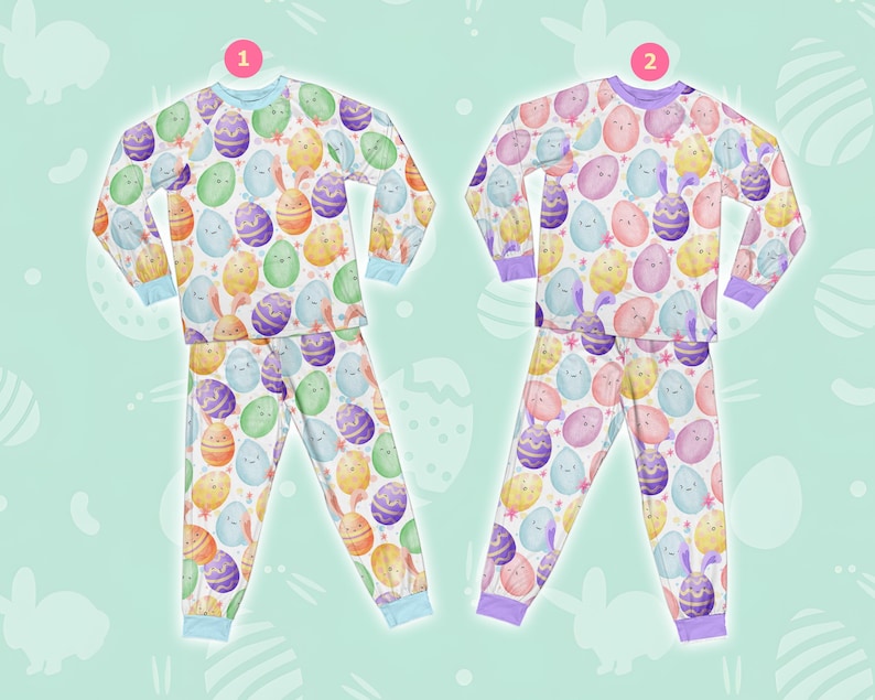 May include: Two pairs of pyjamas with a white background and a colourful Easter egg pattern. The pyjamas have long sleeves and long trousers. The pyjamas are in different colours, one with blue trim and one with purple trim.
