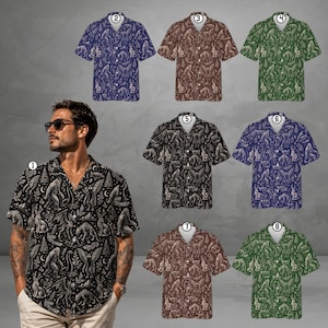 May include: A collection of eight short-sleeved button-down shirts featuring a repeating pattern of cryptids, including Bigfoot, jackalopes, and mothmen, alongside trees and moons. The shirts are available in various colors including blue, brown, and green.