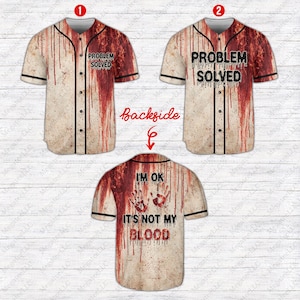 May include: Baseball jersey with a distressed, blood-splattered design. The front features the text "PROBLEM SOLVED" and the back says "I'M OK IT'S NOT MY BLOOD". The jersey has black trim and buttons.