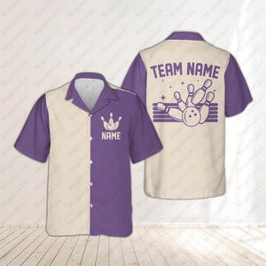 May include: Bowling shirt with a cream and purple color block design. The front features a bowling pin graphic and the word "NAME". The back displays a bowling graphic with the text "TEAM NAME".