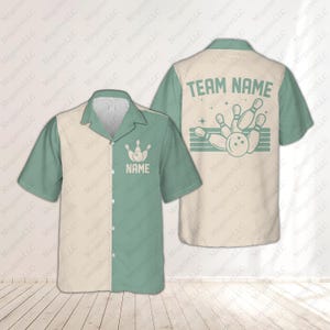 May include: A bowling shirt with a cream and mint green color block design. The front features a bowling pin graphic and the word "NAME". The back displays "TEAM NAME" above a bowling pin and ball graphic.
