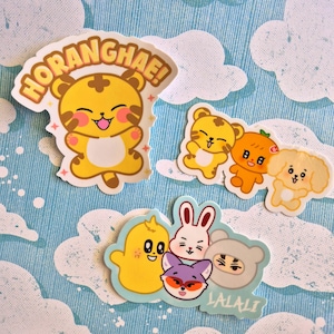 May include: A set of five colourful cartoon animal stickers with the text "HORANGHAE!" and "LALALI" on them. The stickers feature a tiger, a rabbit, a fox, a chick, and a dog.