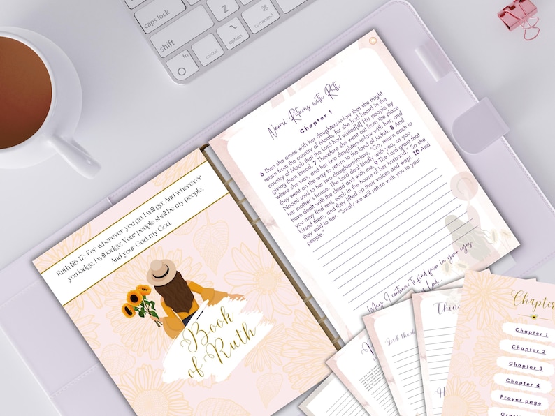 May include: A pink and peach journal with a floral design and the text "Book of Ruth" on the cover. The journal has a section for writing notes and a section for journaling about the book of Ruth in the Bible.
