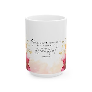 May include: White ceramic mug with a pink and gold floral design. The mug features the text "You are fearfully and wonderfully made. You are beautiful. Psalms 139:14."