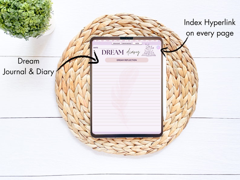 May include: A digital planner app on a tablet with the title "DREAM diary" and the text "DREAM REFLECTION". The app has a pink and white color scheme and features a floral design. The tablet is on a woven straw mat.