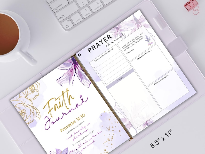 K&ouml;nnte beinhalten: Ein Journal mit violettem und goldenem Blumendesign mit den Worten "Faith Journal" und einem Bibelvers, "Spr&uuml;che 31:30 Anmut ist tr&uuml;gerisch, und Sch&ouml;nheit ist verg&auml;nglich, aber eine Frau, die den Herrn f&uuml;rchtet, ist w&uuml;rdig, gelobt zu werden." Das Journal ist auf einer Seite mit den Worten "Prayer Journal" ge&ouml;ffnet und bietet einen Abschnitt zum Aufschreiben von Gebeten, beantworteten Gebeten und Personen, f&uuml;r die man beten m&ouml;chte. Das Journal misst 21,6 cm x 27,9 cm.