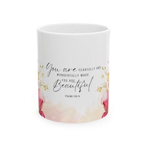 May include: White ceramic mug with a pink and gold floral design. The mug features the text "You are fearfully and wonderfully made. You are beautiful. Psalms 139:14"
