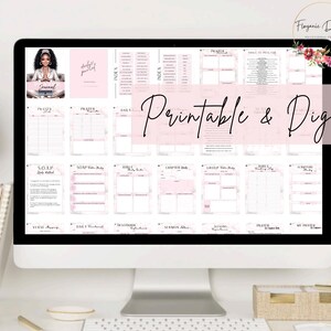 May include: A computer screen displaying a digital planner with pink and white design elements. The planner includes sections for prayer, scripture study, and daily reflection. The text "Printable & Digital" is displayed on the screen.