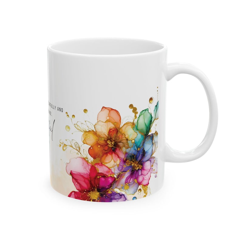 May include: White ceramic mug with a colorful floral design and gold accents. The text "Beautifully and bravely be yourself" is printed on the mug.