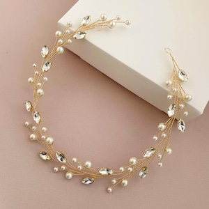 May include: A gold hair vine with pearl and crystal accents. The vine is flexible and can be styled in a variety of ways.