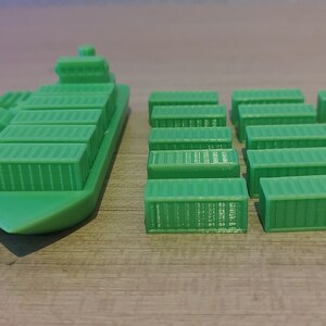 May include: A green toy cargo ship with a row of containers on deck, and a set of 15 green toy cargo containers.