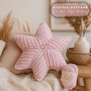 May include: A light pink, crocheted star pillow with a textured design. The pillow is on a beige surface with a ball of yarn next to it. The text "DIGITAL PATTERN Crochet Star Pillow" is at the top of the image.