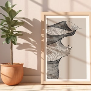 May include: A framed black and white line drawing of a desert landscape with two figures standing on a dune. The background is a light beige color.