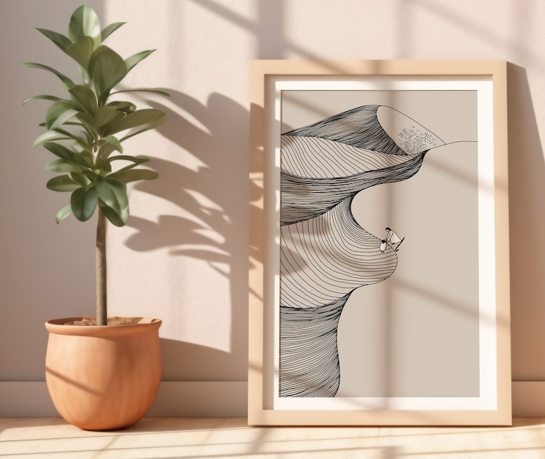 May include: A framed black and white line drawing of a desert landscape with two figures standing on a dune. The background is a light beige color.