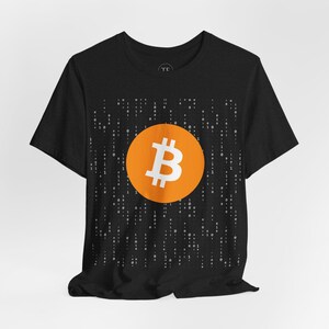 May include: Black t-shirt with a white Bitcoin symbol on an orange circle against a background of white 1s and 0s.