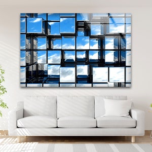 May include: Abstract wall art featuring a grid of black cubes reflecting a blue sky with white clouds. The cubes are arranged in a three-dimensional pattern, creating a sense of depth and perspective.