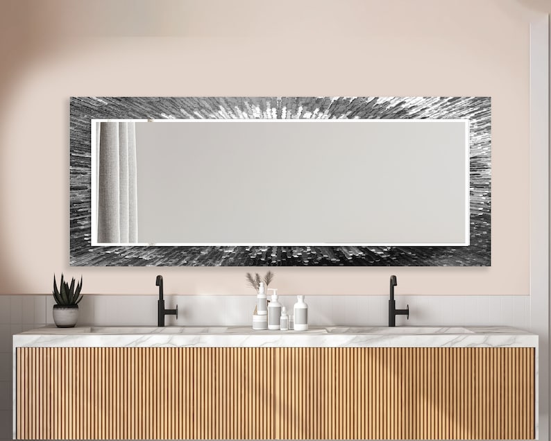 a bathroom vanity with a large mirror above it